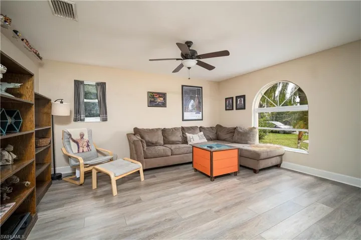 Living room featuring hardwood / wood-style flooring and ceiling fan