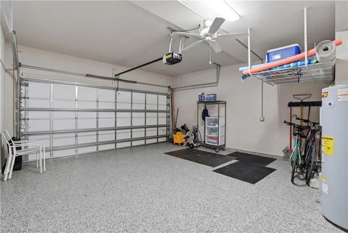 Garage featuring water heater and a garage door opener