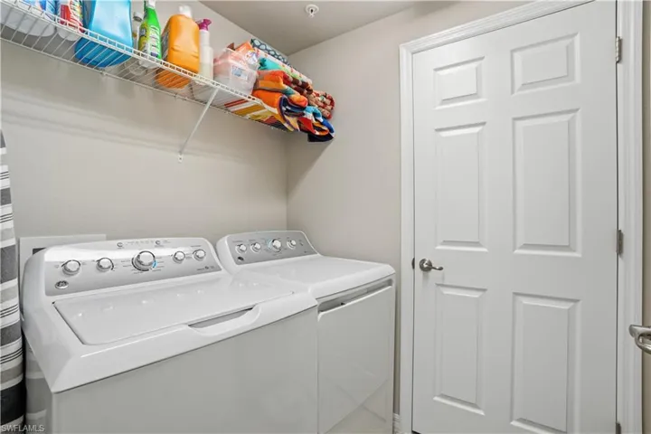 Laundry room with washing machine and clothes dryer