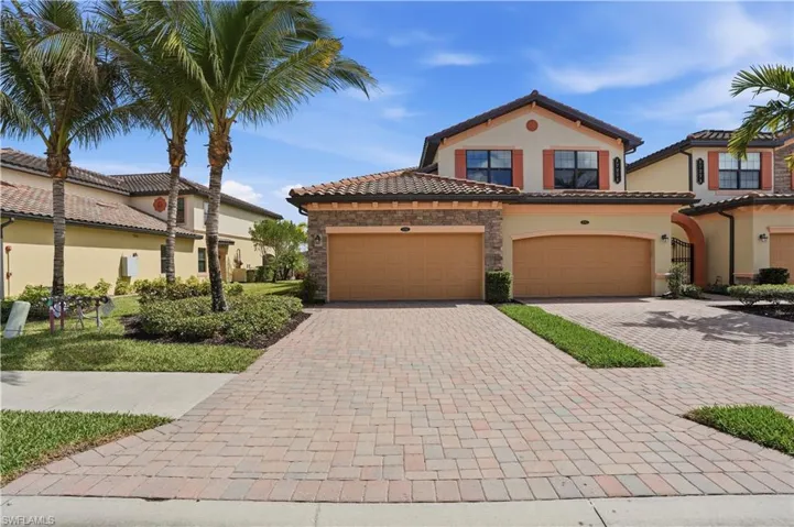 Mediterranean / spanish-style house with driveway, stucco siding, a garage, stone siding, and a tiled roof