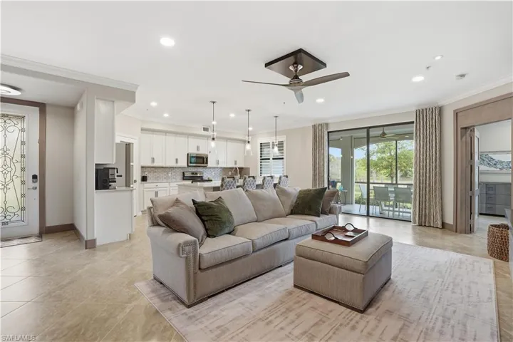 Living area with a ceiling fan, crown molding, recessed lighting, and light tile patterned floors