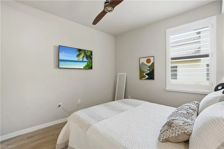 Bedroom with wood finished floors and ceiling fan
