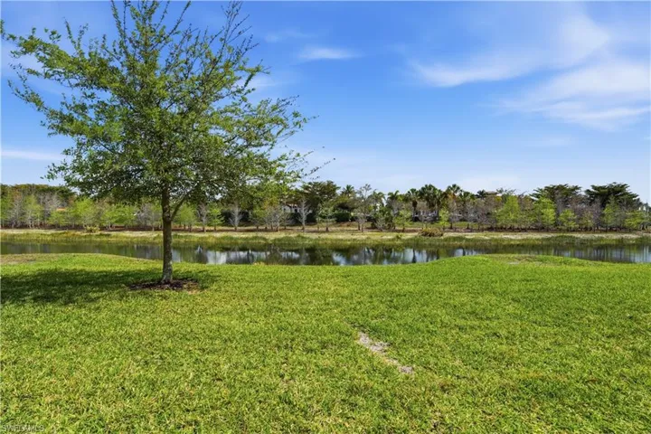 View of green lawn with a water view