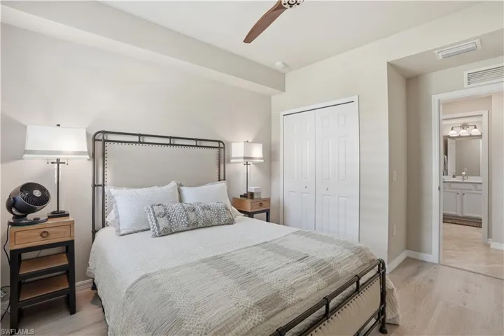 Bedroom featuring light wood finished floors, ceiling fan, and a closet