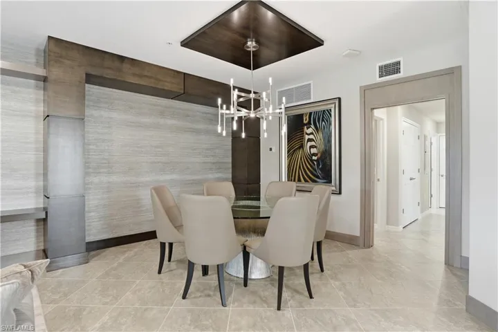 Dining space featuring baseboards and hanging lights