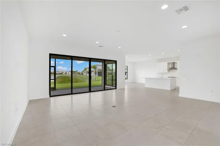 Unfurnished living room featuring light tile patterned floors