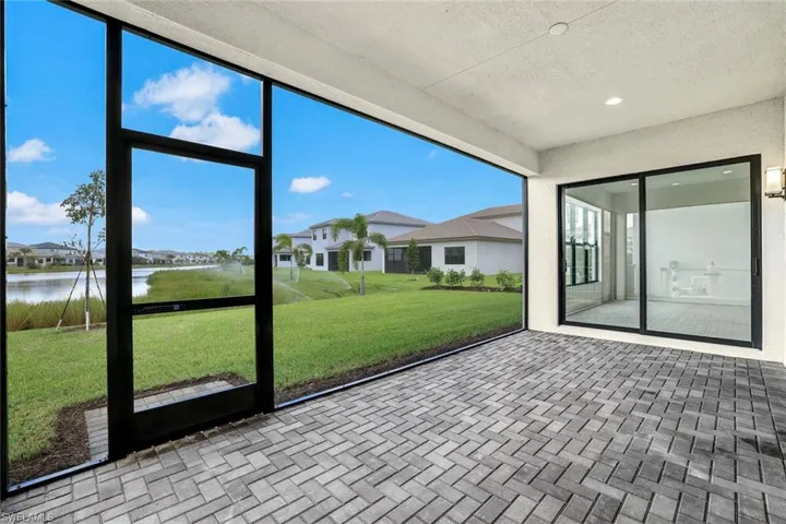 Unfurnished sunroom featuring a water view