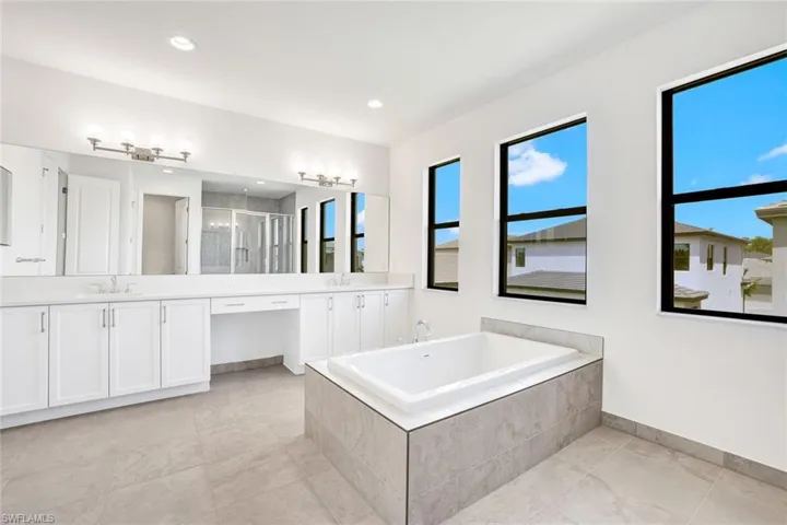 Bathroom featuring vanity and plus walk in shower