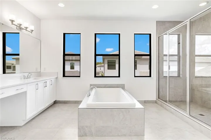 Bathroom featuring independent shower and bath and vanity