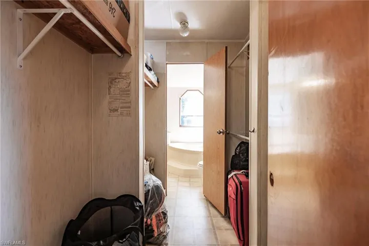 Walk in closet with light tile patterned flooring