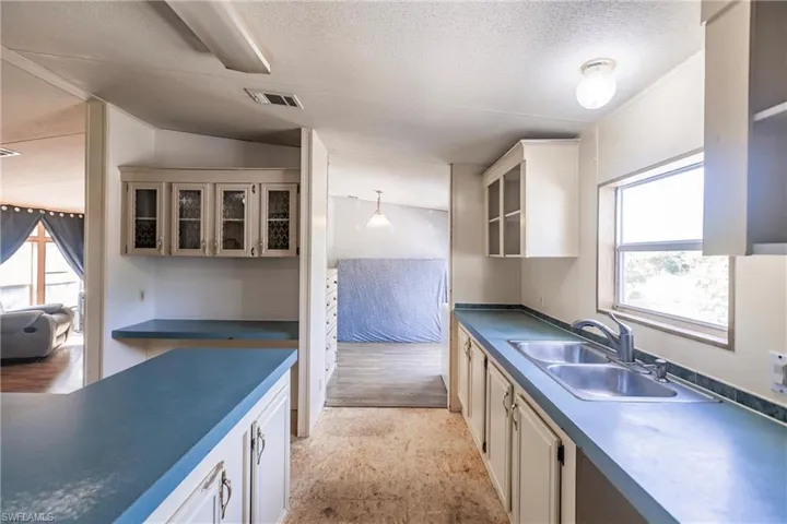 Kitchen with sink, light hardwood / wood-style flooring, and a wealth of natural light