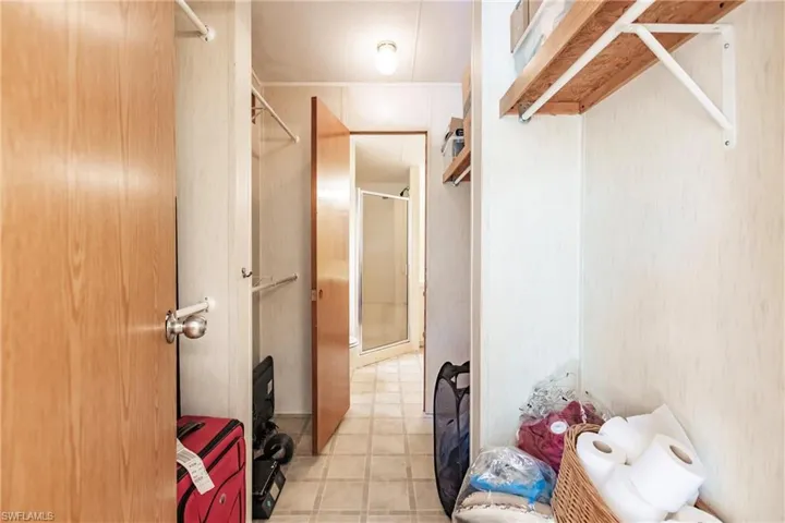 Spacious closet with light tile patterned floors
