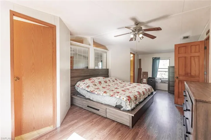 Bedroom featuring ceiling fan and hardwood / wood-style floors