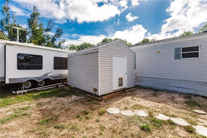 View of property exterior featuring a shed