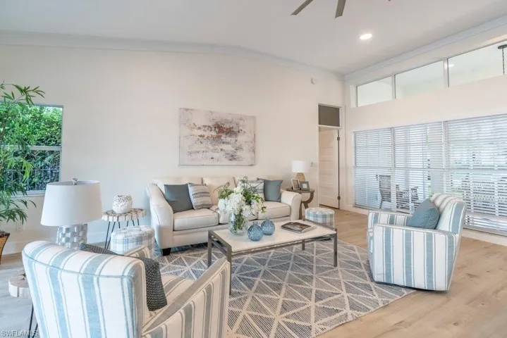Great room has crown molding, custom baseboard, top quality Mohawk luxury vinyl plank floors, new LED lighting and a healthy amount of light and views of the lake to cheer up even the rainy days.