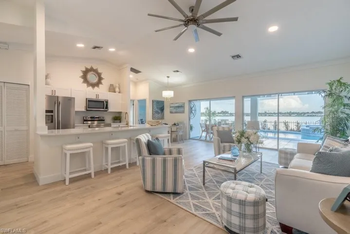 Open floor plan with vaulted ceiling is light and bright and makes the kitchen, dining and living room feel spacious.