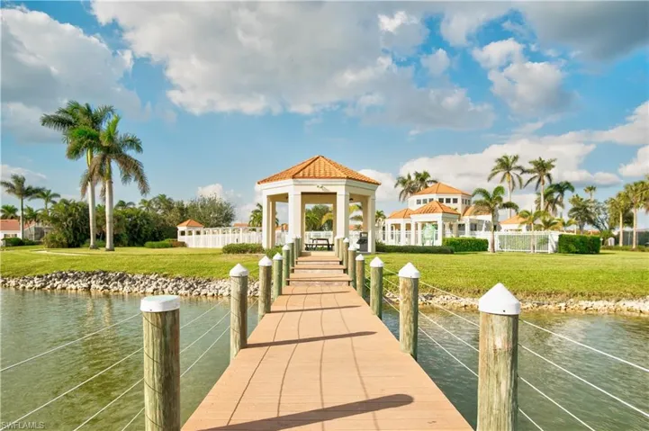 Dock area with a water view and a lawn