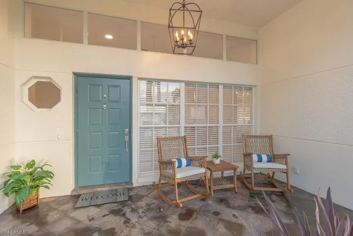 Front porch has been opened up and modernized, with new lighting and front door with Mediterranean flair.