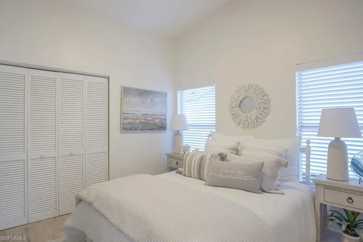 Guest Bedroom features vaulted ceiling with new coastal-style ceiling fan, a spacious double closet and two windows to bring in lots of light.