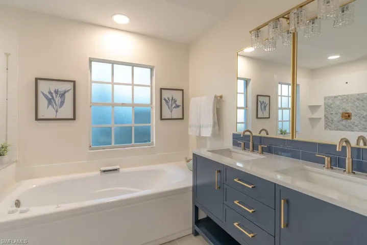 Primary bathroom with soaking tub, new LED lighting, new vanity, sinks, fixtures and lighting.