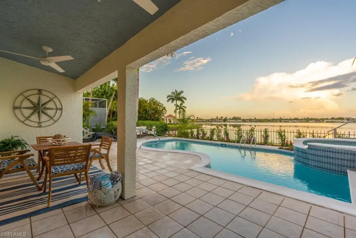 Painted lanai ceiling is blue to bring in the colors of the water and the pool tile. Two brand new white ceiling fans grace the ceiling and provide a breeze on hot days!