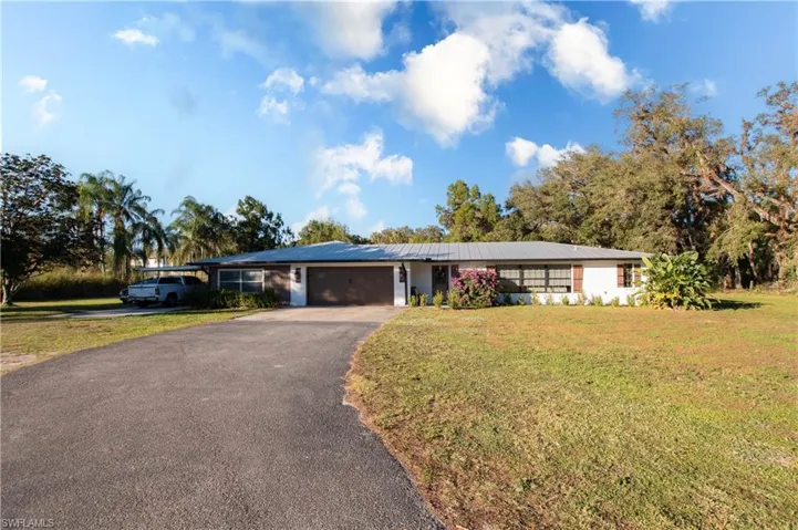 Ranch-style home with a front lawn