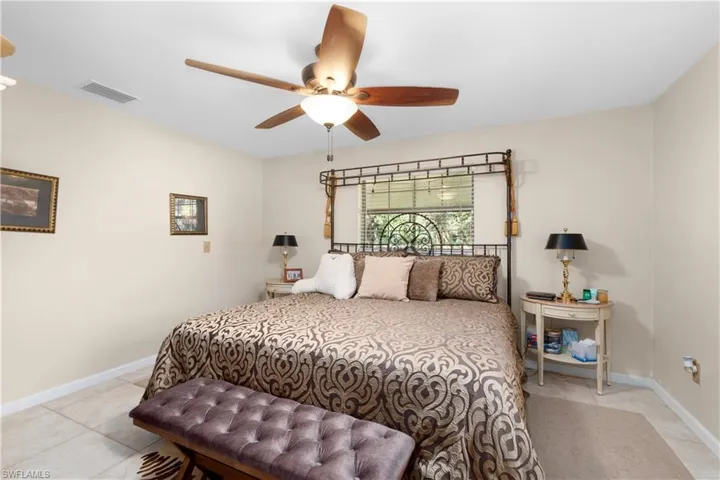 Tiled bedroom with ceiling fan