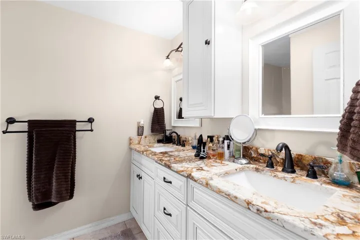 Bathroom featuring tile patterned floors and vanity