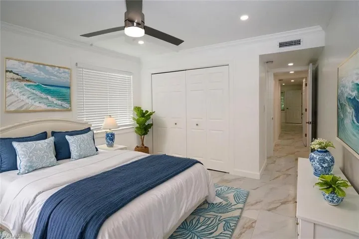 Guest Bedroom featuring visible vents, recessed lighting, marble finish floor, a closet, and ornamental molding