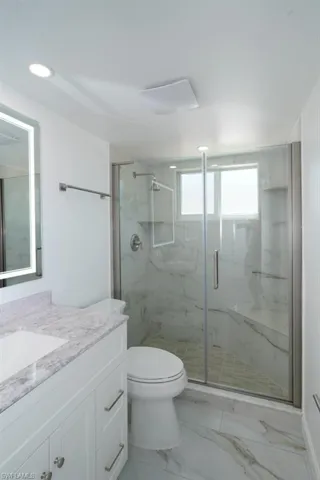 Master Bathroom featuring high seat toilet, recessed lighting, and new vanity.