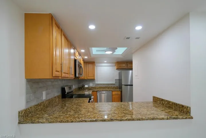 Kitchen featuring Recessed Lighting, new Stainless steel Appliances appliances, new ceiling fan, recessed lighting, new backsplash and granite counters