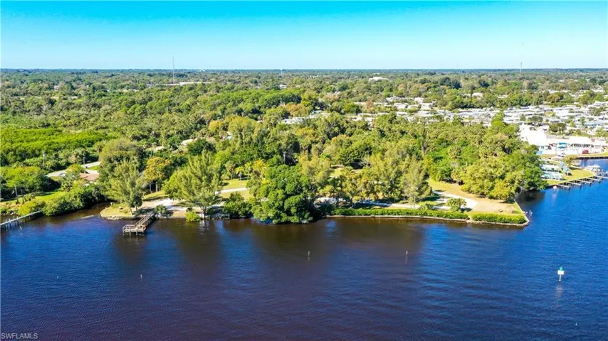 Aerial view with a water view and a forest view