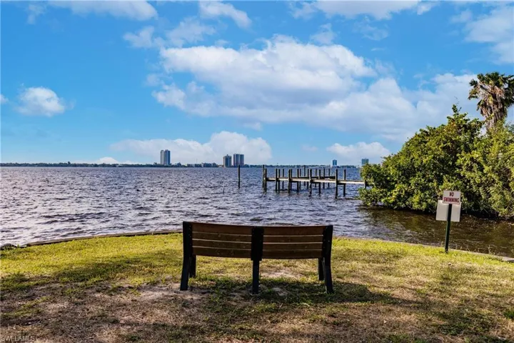 Dock area featuring a lawn and a water view