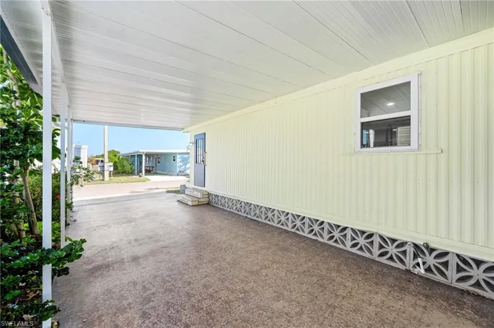 View of patio with entry steps and an attached carport