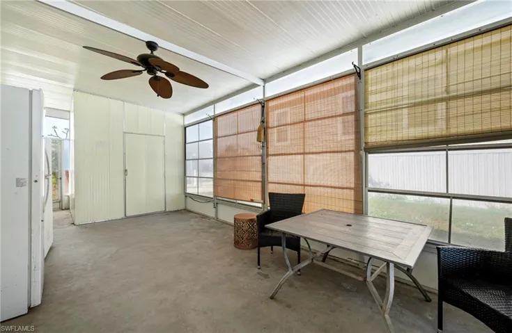 Sunroom featuring ceiling fan and outdoor dining area