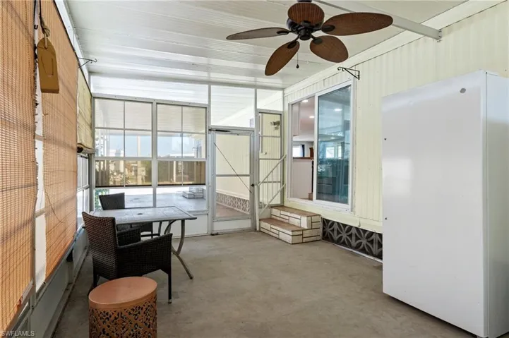 Sunroom / solarium featuring a healthy amount of sunlight and a ceiling fan