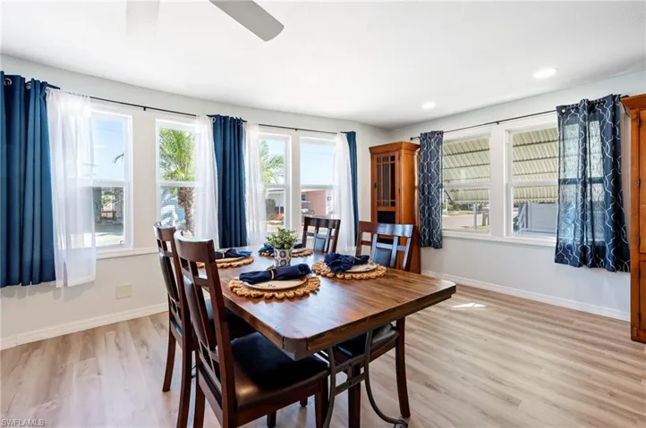 Dining area with light wood-style floors, ceiling fan, baseboards, and recessed lighting