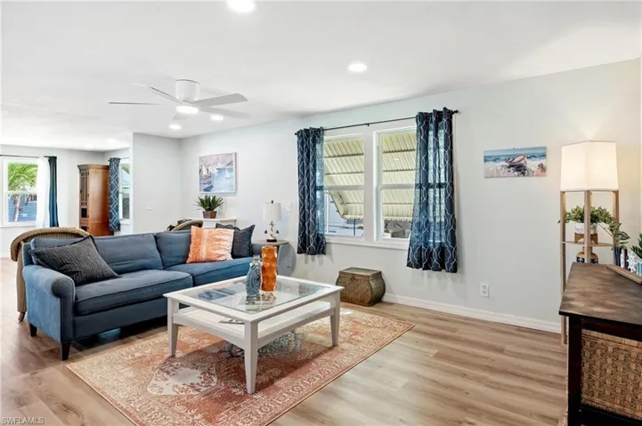 Living room featuring recessed lighting, light wood-type flooring, and a ceiling fan