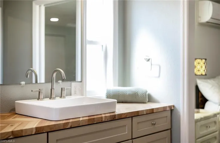 Bathroom featuring vanity and an AC wall unit
