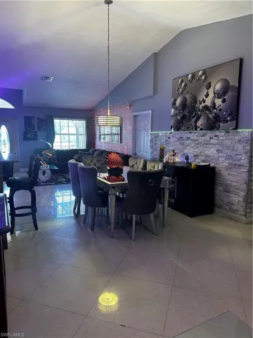 Tiled dining room with vaulted ceiling