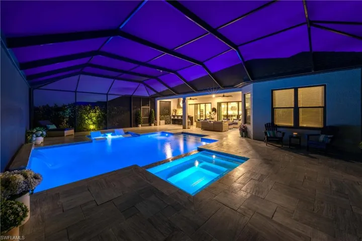 View of swimming pool featuring an in ground hot tub, an outdoor living space, a lanai, and a patio area