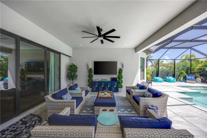 View of patio with outdoor lounge area, a lanai, and ceiling fan