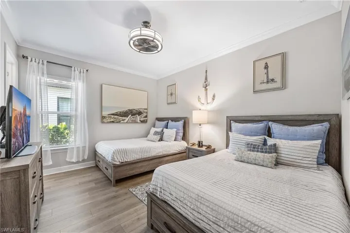 Bedroom featuring crown molding and light hardwood / wood-style floors