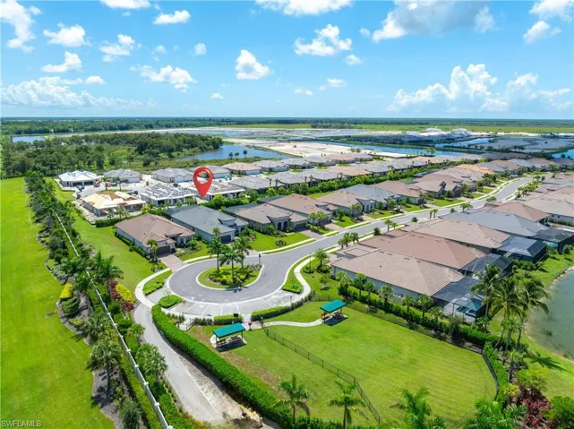 Birds eye view of property with a water view