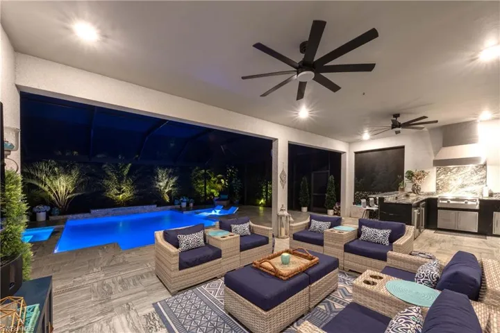 View of patio featuring ceiling fan, an outdoor hangout area, and an outdoor kitchen
