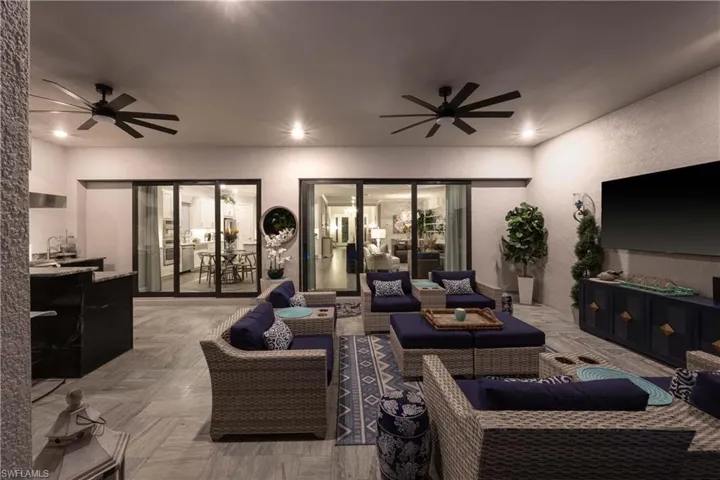 Living room featuring sink and ceiling fan