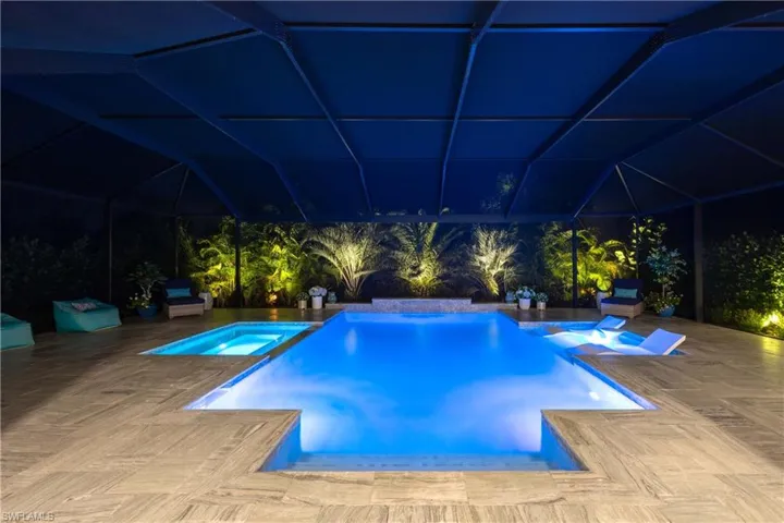 View of swimming pool featuring a patio and an in ground hot tub