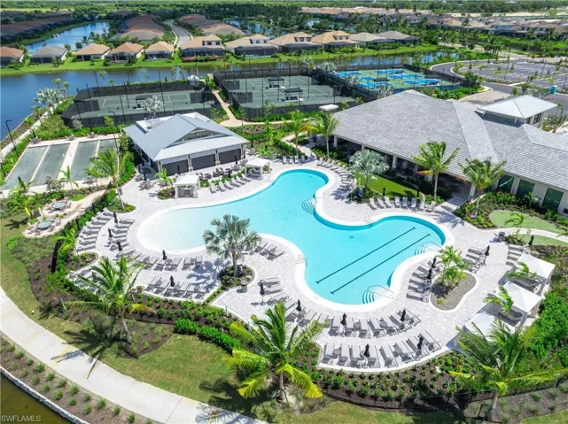 View of pool with a patio and a water view