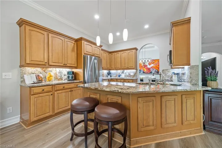 Solid wood cabinets, fully appointed, breakfast bar.
