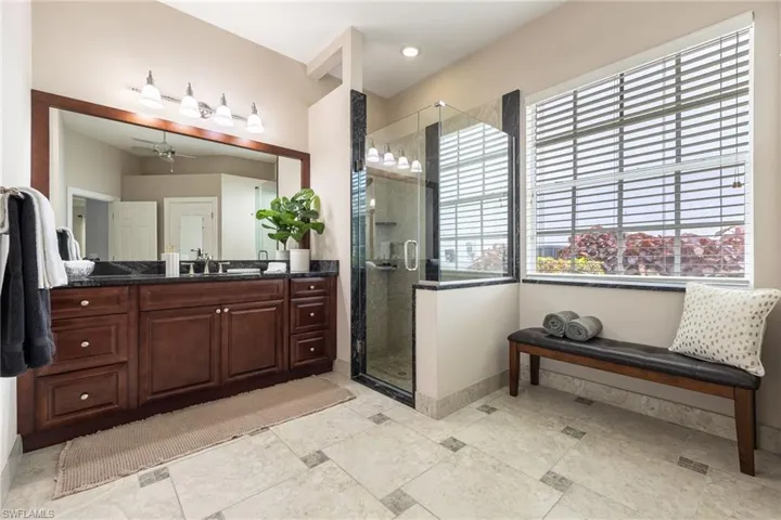 Glassed in shower, sitting area and has private water closet.